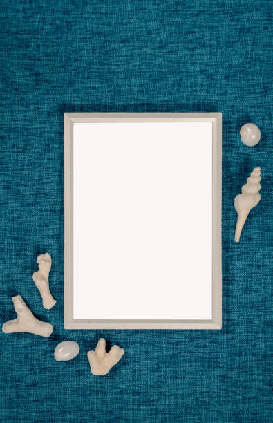 istock Top view of Blank picture frame with scattered sea shells, White frame isolated on blue background ,Beach photos stock image 2189520853