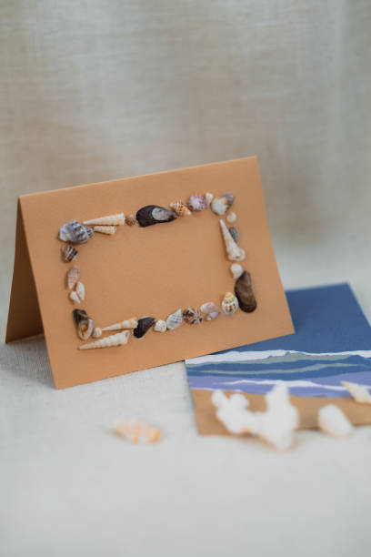 Vertical Stock Photo of Envelope Mockup with Seashell Frame, Beach-Themed Gifting Idea, space for copy text