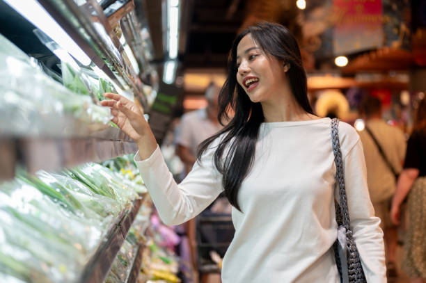 istock An attractive Asian woman selecting vegetables from a shelf while grocery shopping at a supermarket. 2189522406