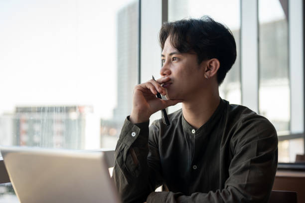 istock A thoughtful Asian businessman admiring the view outside with a serious expression while working. 2189522884