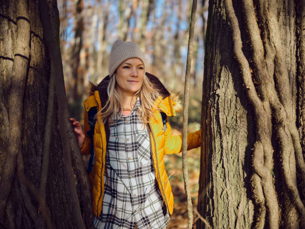 istock Smiling female backpacker having a break among trees in nature. 2189523921