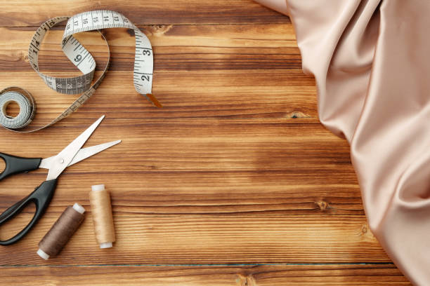istock Crafting tools and materials arranged on a wooden table for sewing projects 2189528739