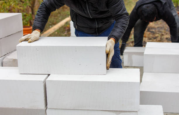 istock Two men are laying bricks on top of each other 2189529050