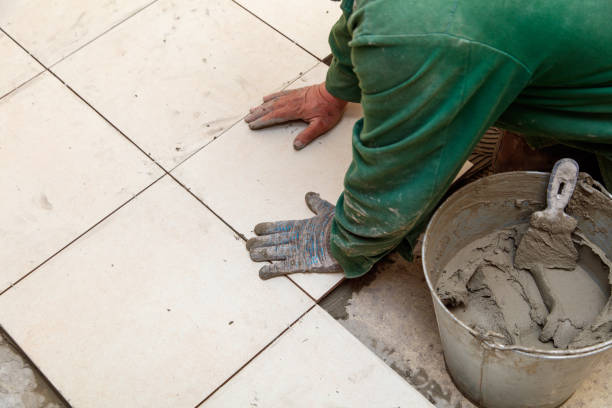 istock A man is laying tiles on a floor 2189529916