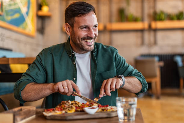 Tasting Italy - Man enjoying authentic pizza in a local pizzeria