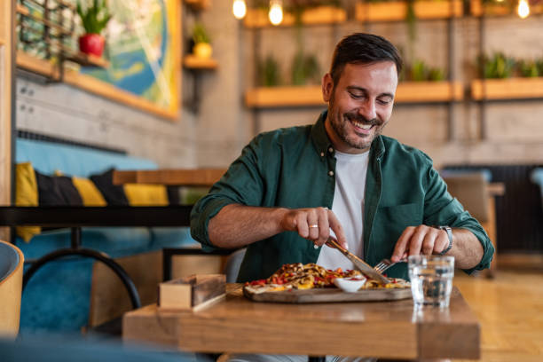 istock Tasting Italy - Man enjoying authentic pizza in a local pizzeria 2189533654