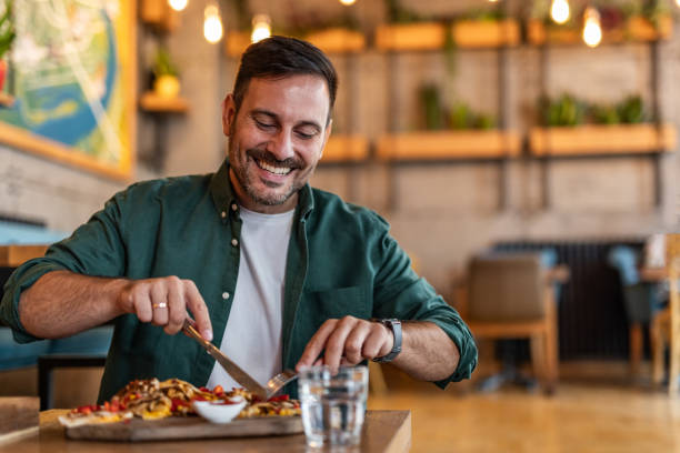 istock Tasting Italy - Man enjoying authentic pizza in a local pizzeria 2189533655