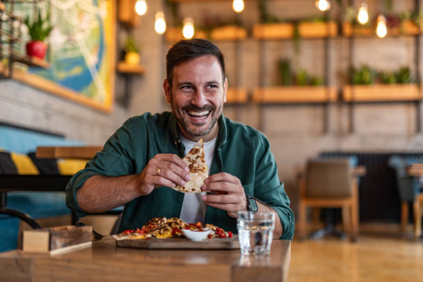 istock Tasting Italy - Man enjoying authentic pizza in a local pizzeria 2189533667
