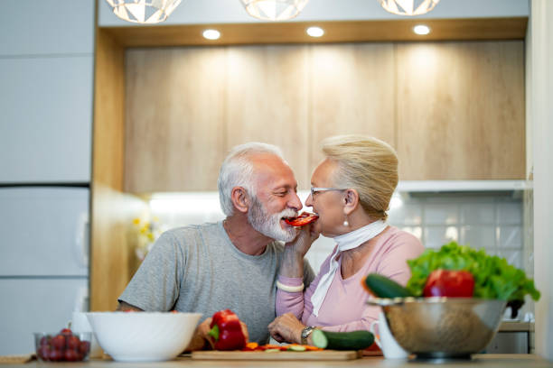 istock Happy Senior Couple Sharing a Romantic Moment in Kitchen 2189535279
