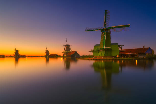 istock Zaanse Schans, Netherlands. Historical place in the Netherlands during sunset. Reflections in the canal. An old open-air museum. Photo for background, wallpaper, postcards. 2189535620
