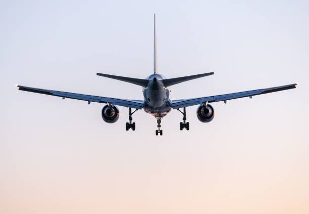 istock Airplane approaching for landing against a clear sky 2189535673
