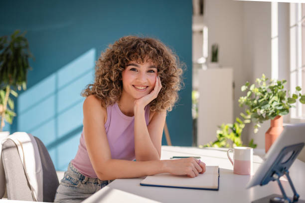 istock Smiling Young Woman Working at Desk in Bright Modern Home Office Space 2189536001