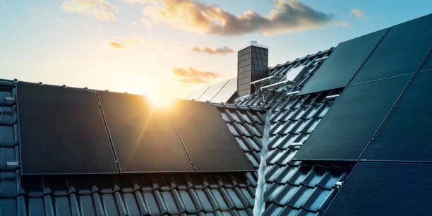 istock Modern home with solar panels on the roof at sunset 2189536801