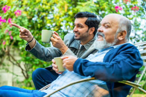 istock Father and son bonding outdoors, sitting together with coffee and sharing a lighthearted moment 2189537077