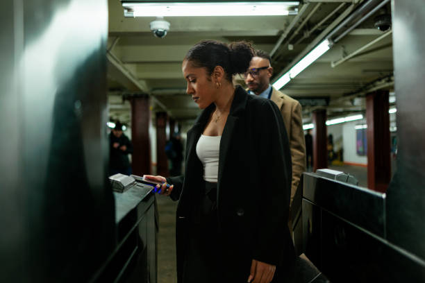 istock Businesswoman using smart phone to enter subway station 2189537370