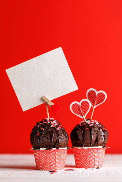 istock Cupcake love: Heart-themed treats on a vibrant red backdrop 2189539399