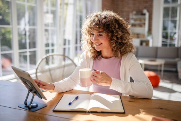 istock Woman Working at Home Office Desk with Tablet and Notebook 2189540906