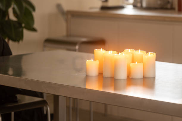 Several lit candles on a metal table create a warm and inviting atmosphere