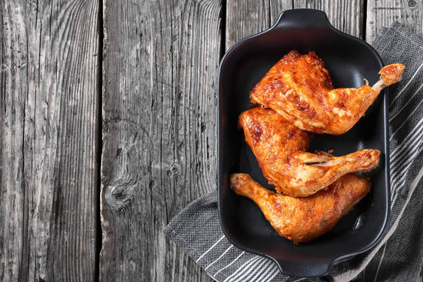 istock baked in oven three chicken leg quarters, top view 2189542944
