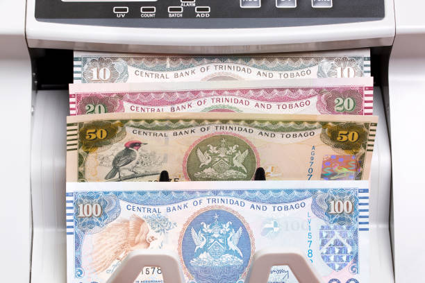 istock Trinidad and Tobago dollar in the counting machine 2189543009