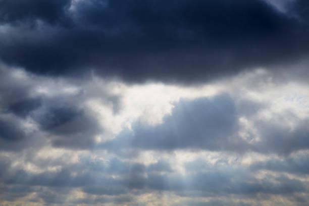 Light breaks through the rain clouds in the sky, light passes through the clouds, rays of light through the clouds.