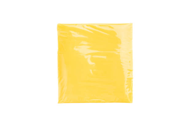 istock Square  Slices of processed Cheddar cheese in individual plastic packaging isolated on white background 2189544112