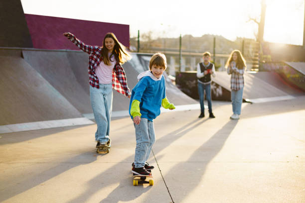 istock Children skateboarding at skateboard park 2189548799