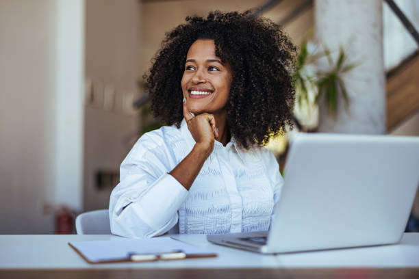 istock Confident Young Professional Smiling While Working on Laptop in Modern Office 2189549234