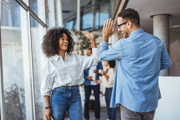 istock Joyful Colleagues Celebrating Success With a Lively High Five 2189549628
