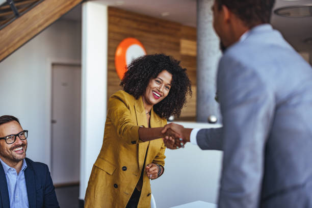 istock Two Business Professionals Shaking Hands in a Successful Office Collaboration 2189550089
