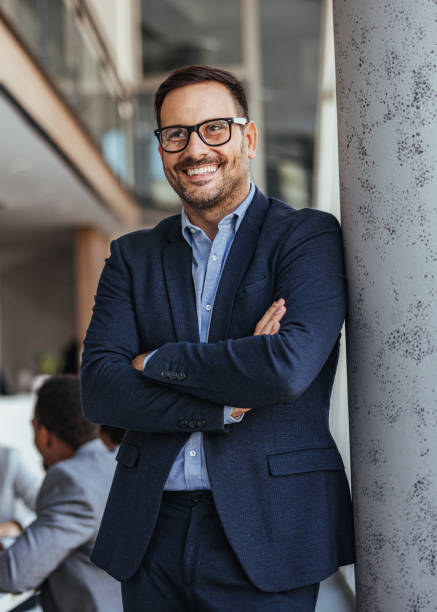 istock Confident Businessman in Modern Office Environment Smiling 2189550229