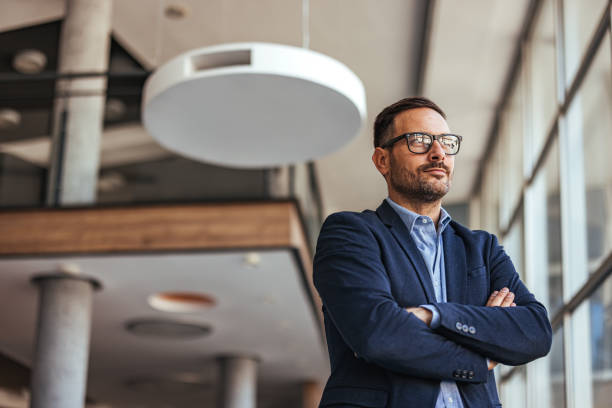 istock Confident Businessman Standing in Modern Office Environment 2189550435