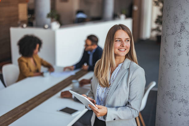 istock Confident Businesswoman Holding Tablet in Modern Office Setting 2189550577