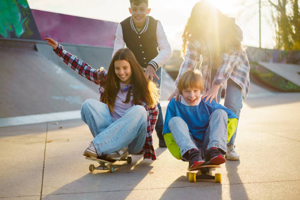 istock Children have fun skateboarding in the park 2189550701