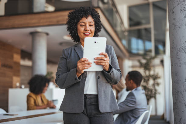 istock Confident Businesswoman Using Digital Tablet in Modern Office Space 2189550707