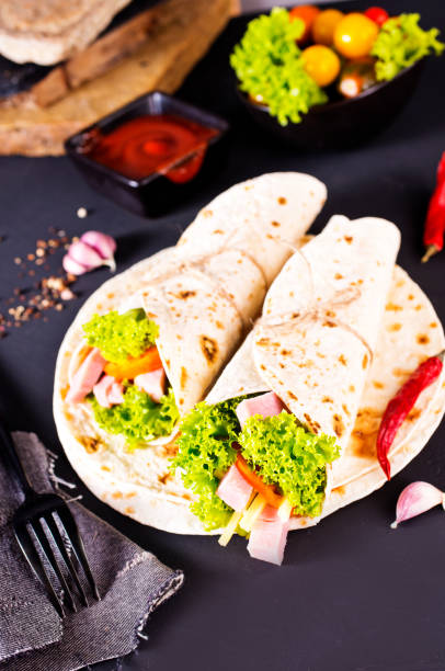 istock Shawarma sandwich, fresh roll of lavash (pita bread) pork shawarma with ham and cheese 2189551398