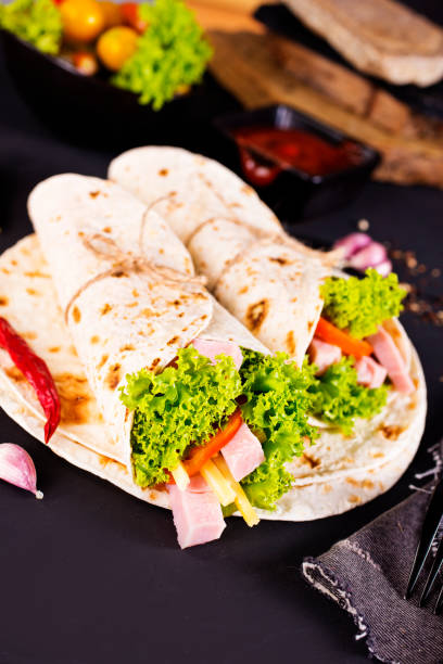 istock Shawarma sandwich, fresh roll of lavash (pita bread) pork shawarma with ham and cheese 2189551407
