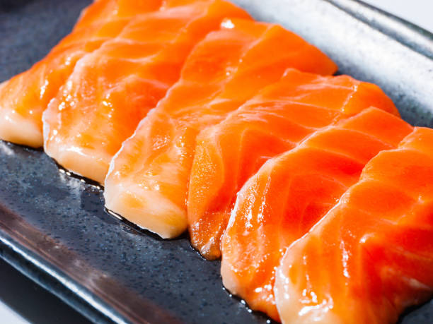istock Salmon sashimi on a black plate, Raw fish dish, Nobody 2189551976