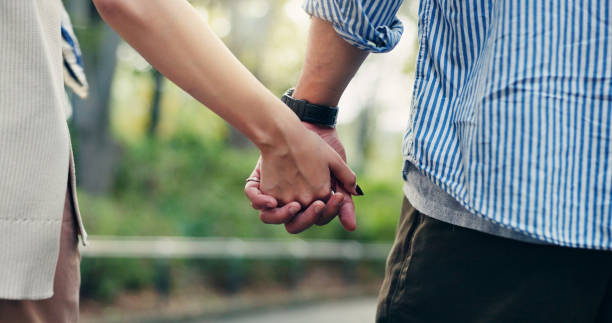 istock Couple, back and outdoor with holding hands, walk and support for romantic getaway or connection. Woman, man and bonding as together for solidarity, love or weekend as tourist for travel 2189552668