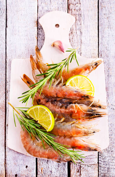 istock Uncooked Raw peeled tiger white shrimp prawn. Top view. 2189554028