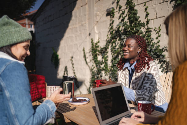 istock Young women talking and drinking coffee in a backyard 2189554936