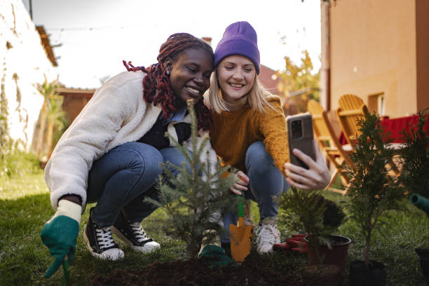 istock Two young women planting and taking photos in backyard 2189555087