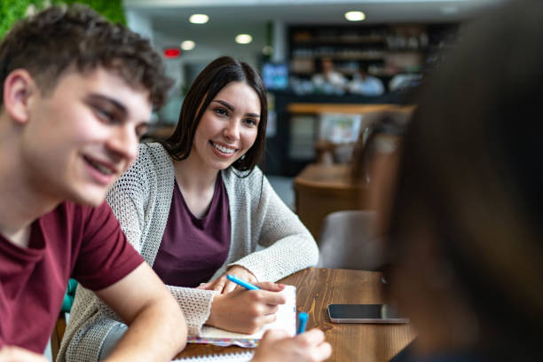 istock Cheerful friends study together in coffee shop 2189555222