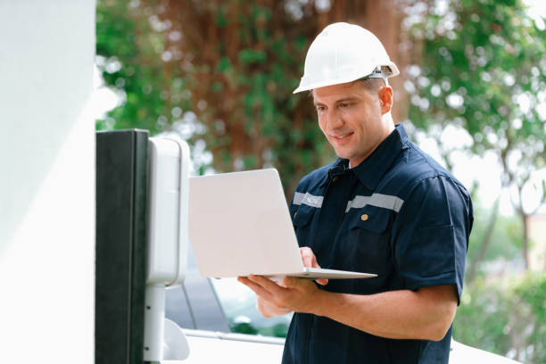 istock Qualified technician working with laptop for home EV station. Synchronos 2189555490