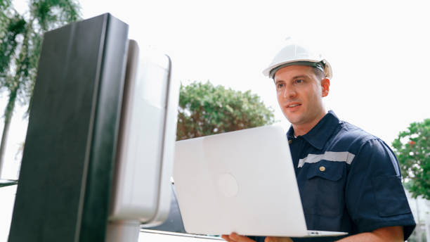 istock Qualified technician working with laptop for home EV station. Synchronos 2189555596