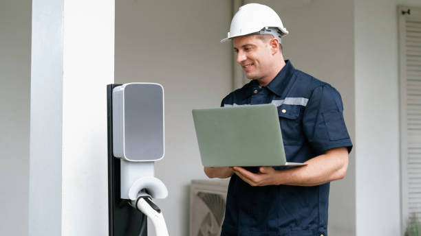 istock Qualified technician working with laptop for home EV station. Synchronos 2189556140