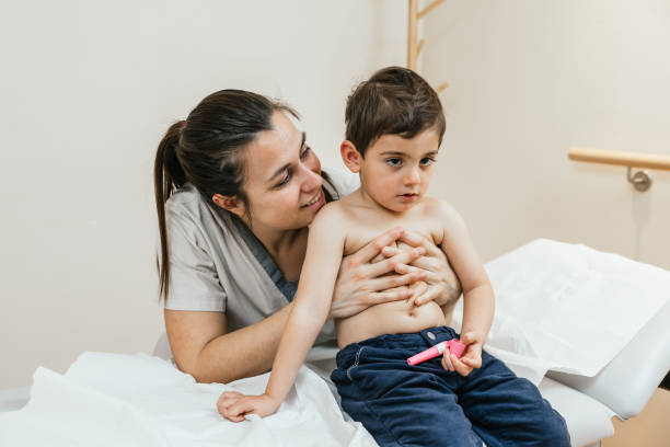 istock Respiratory therapist assisting young boy with breathing exercises 2189556145