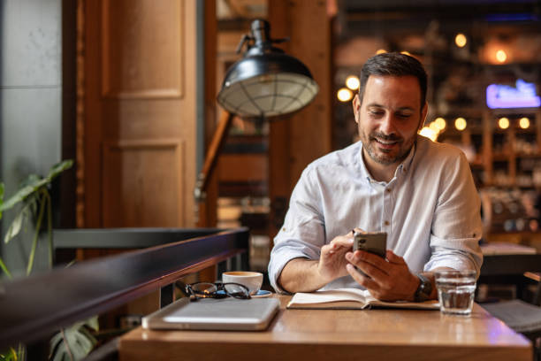 istock Businessman in a cafe - Sipping coffee and writing ideas 2189557076