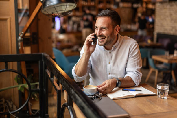 istock Businessman in a cafe - Sipping coffee and writing ideas 2189557092