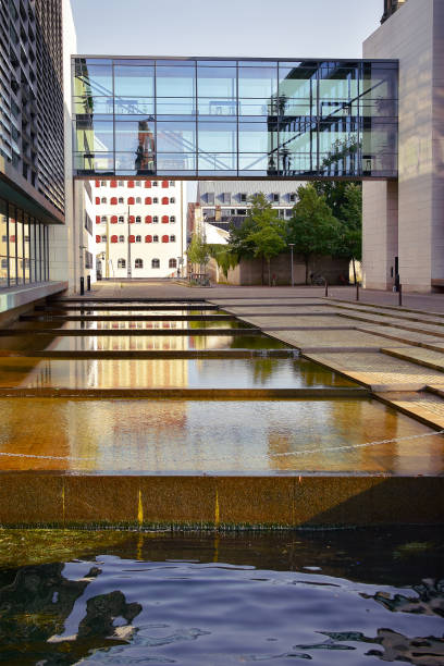 istock Modern glass building with water flowing through an artificial channel. 2189557822